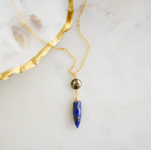This necklace is handmade with natural pyrite and lapis lazuli suspended from a 14k gold filled or sterling silver chain.