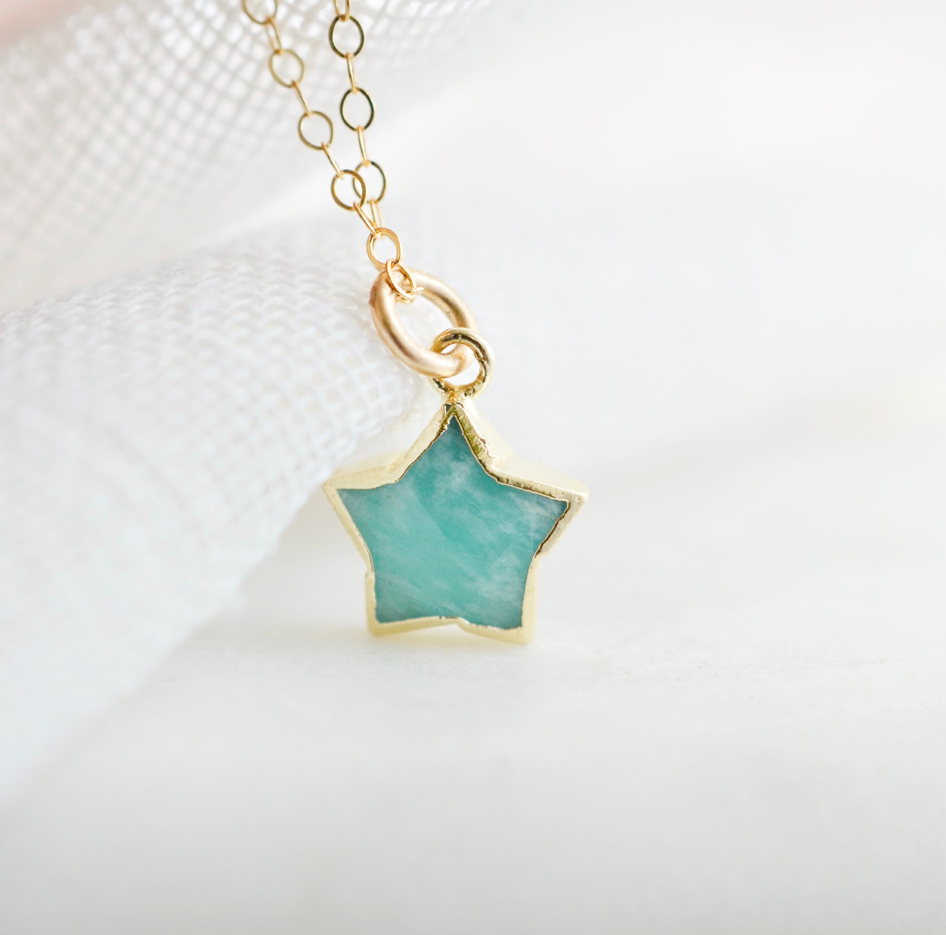 Dainty, natural aqua amazonite celestial stone star pendant set on a 14k gold filled chain. This image is a close up of the gemstone's natural aqua-blue color. This necklace is a great gift for night sky lovers, girlfriends, mom, wife, or daughter.