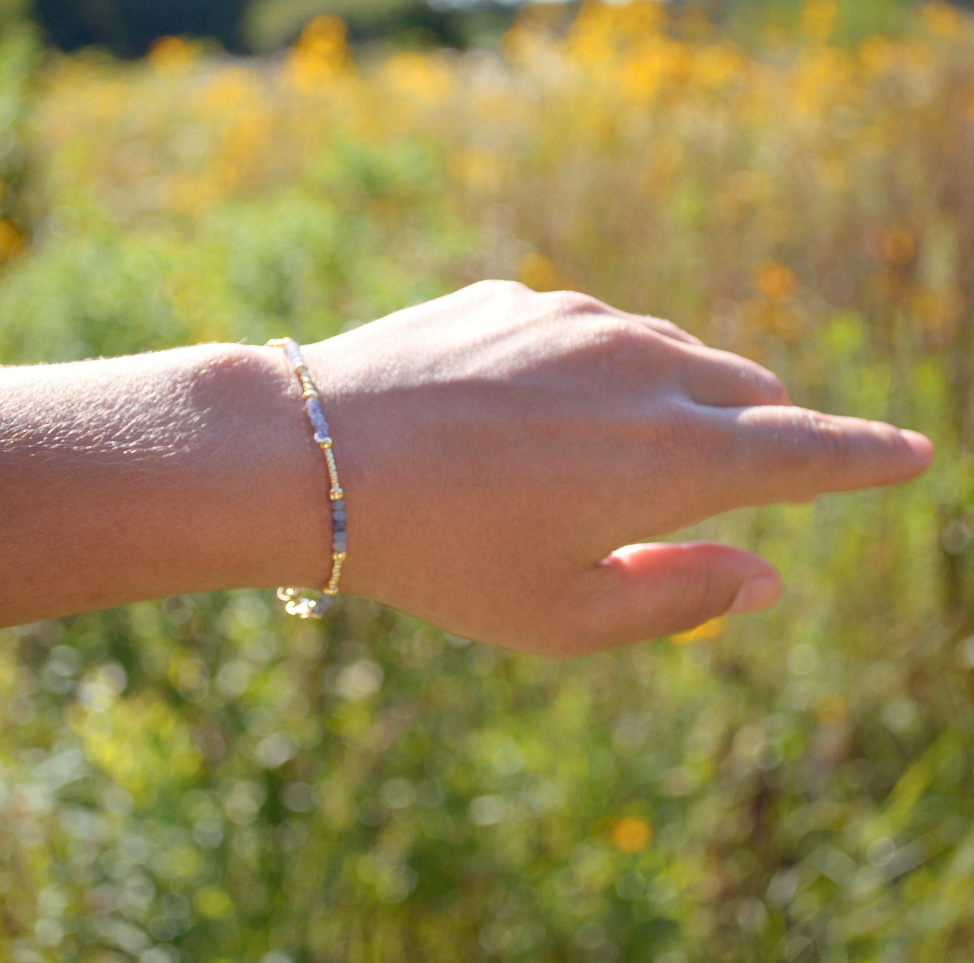 Handmade beaded gemstone crystal bracelet in gold filled or sterling silver. This bracelet is modeled with Tanzanite. These bracelets feature a gemstone of your choice on a bracelet that can be stacked with others or worn alone.