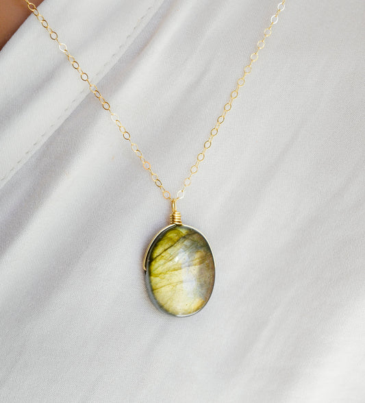 Labradorite oval pendant with yellow-green flash. The chain in 14k gold filled.