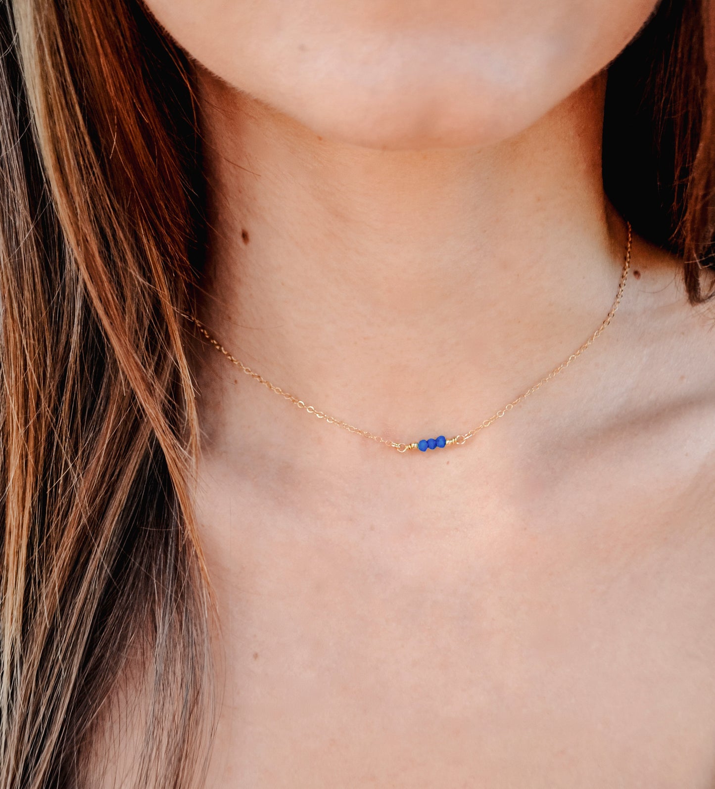 Three genuine Lapis Lazuli stones set onto a sterling silver chain. Modeled image. Connecticut Handmade Jewelry by GEMNIA. 