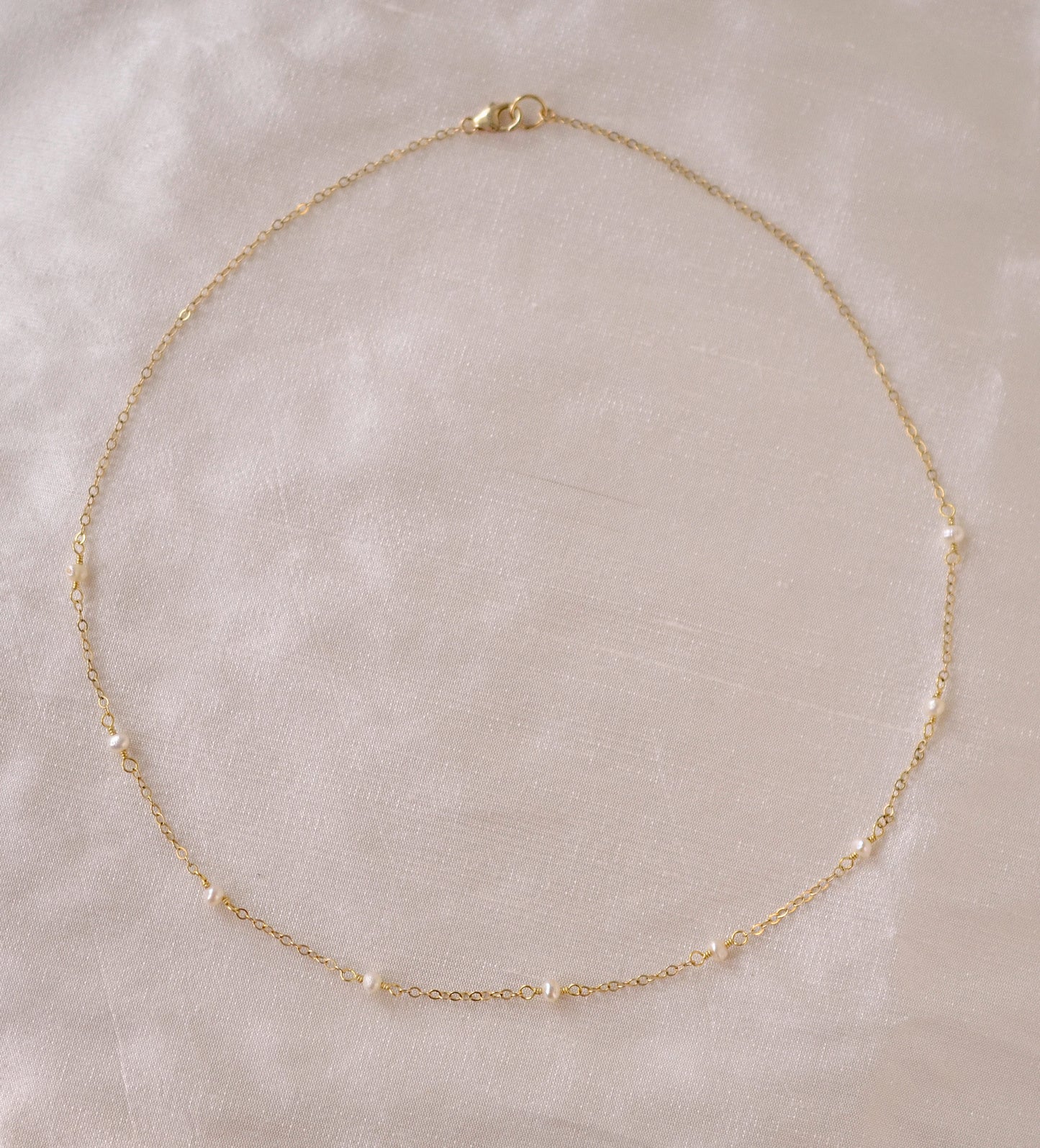 Genuine white freshwater pearls set onto a 14k gold filled chain.