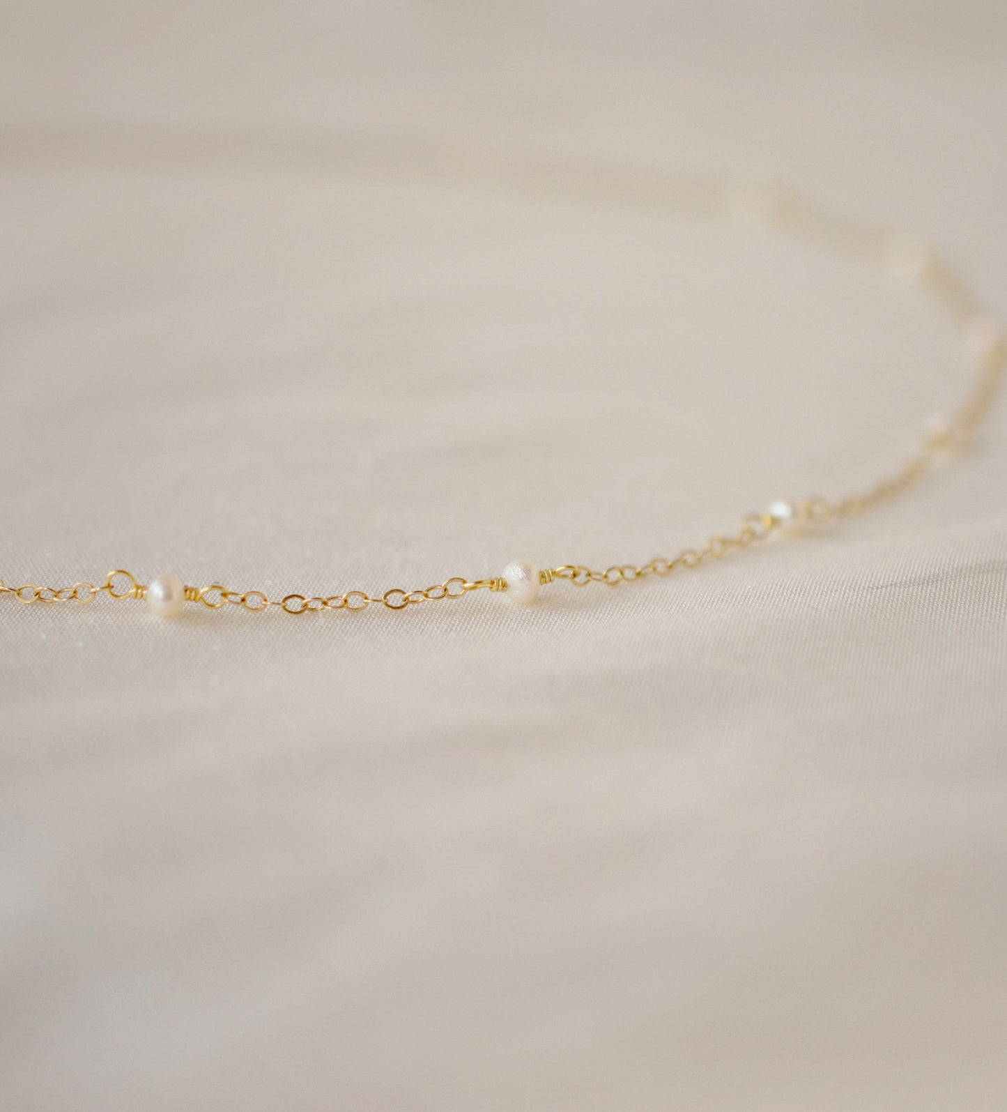 Genuine white freshwater pearls set onto a 14k gold filled chain.