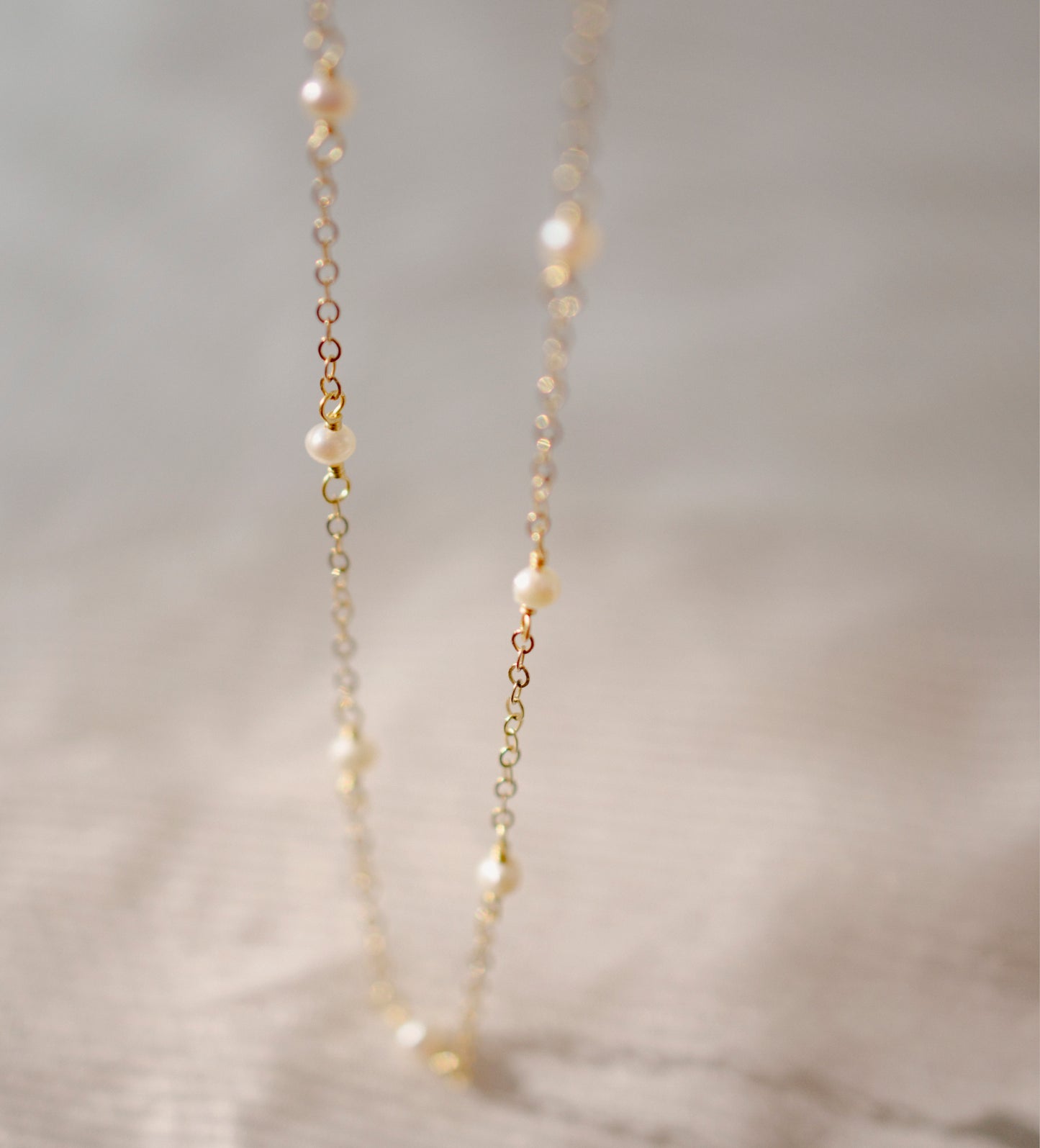 Genuine white freshwater pearls set onto a 14k gold filled chain.