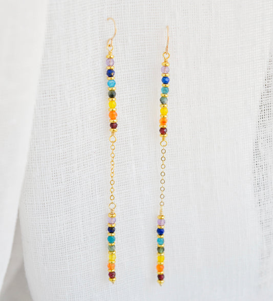 Two long, straight bars of crystals arranged in a rainbow pattern separated by a dainty chain. The gold style is shown. 