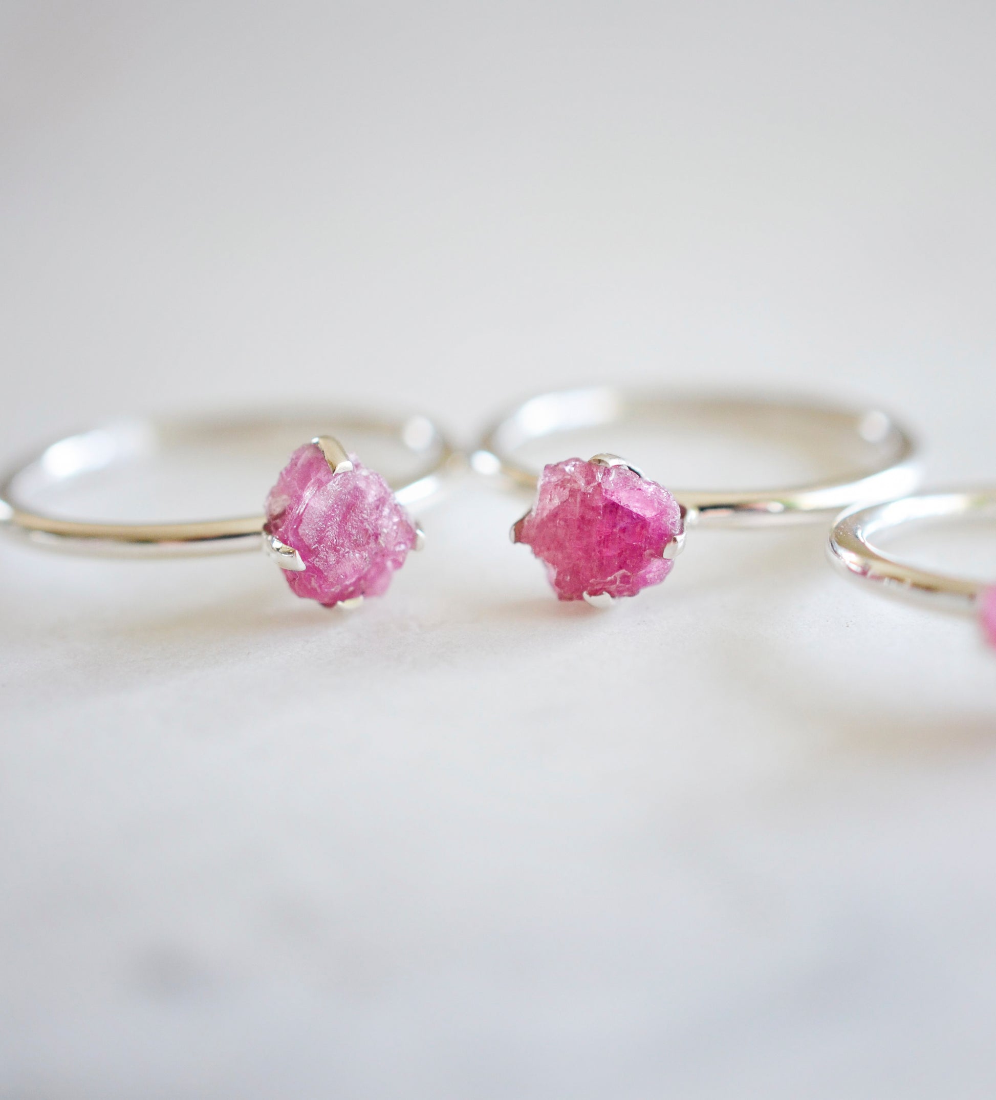 Raw Pink Tourmaline crystals set onto sterling silver rings. Showing two rings.
