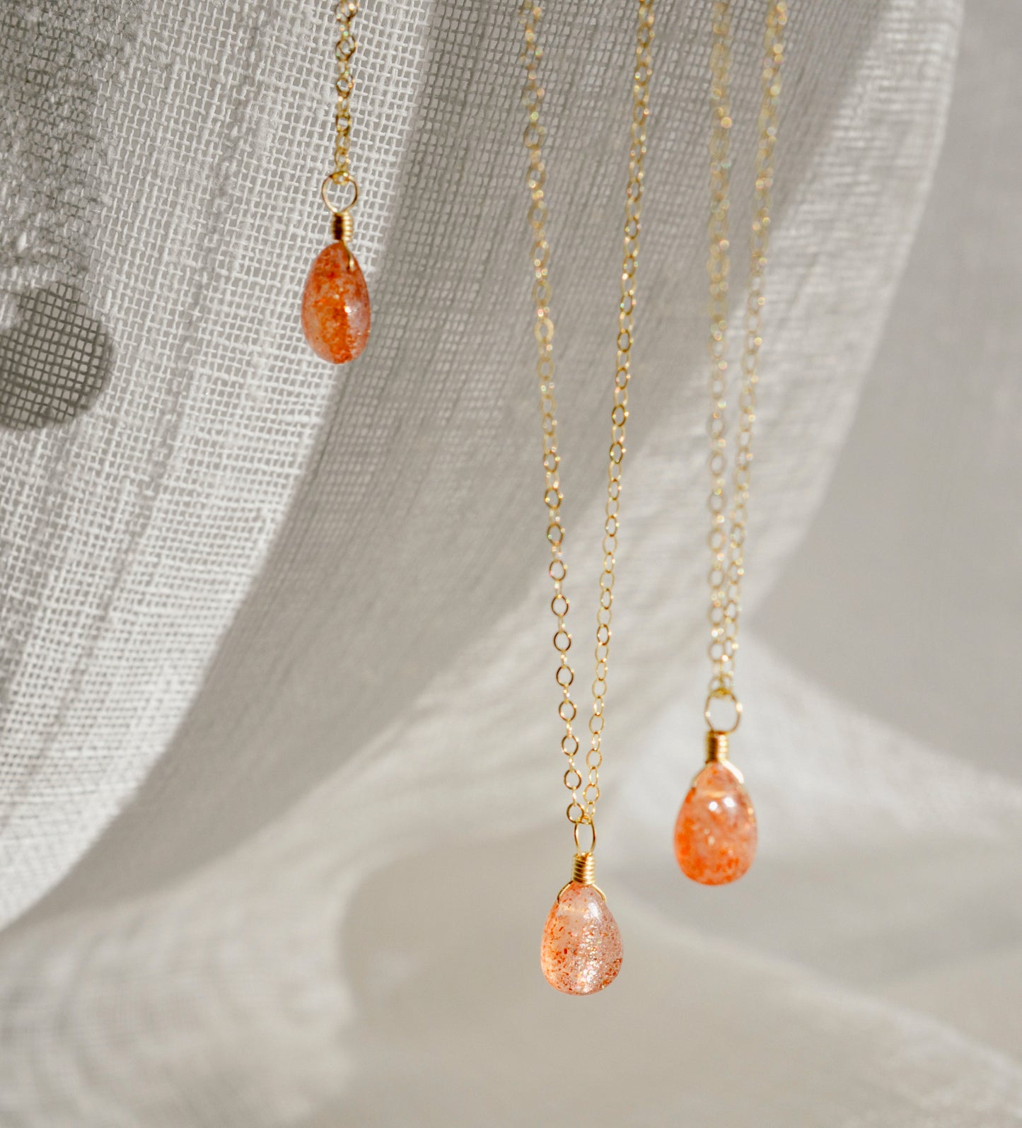 Orange Sunstone smooth polished teardrop pendant on a 14k gold filled chain. Stones shimmer in the light and when turned from side to side.