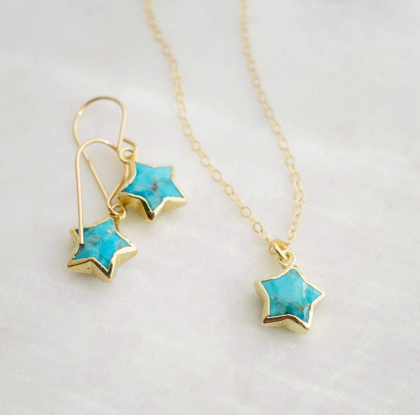 Natural blue turquoise star pendant on a 14k gold filled chain shown with matching earrings.