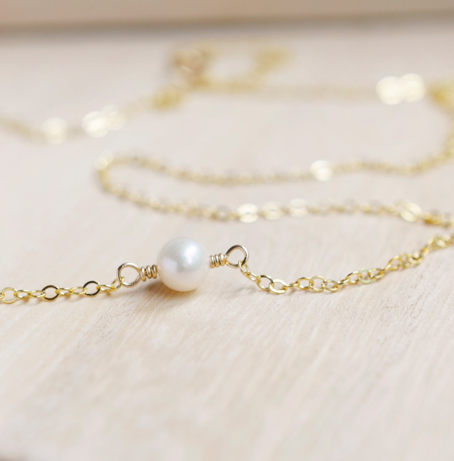 Single round white freshwater pearl necklace on a 14k gold filled chain.