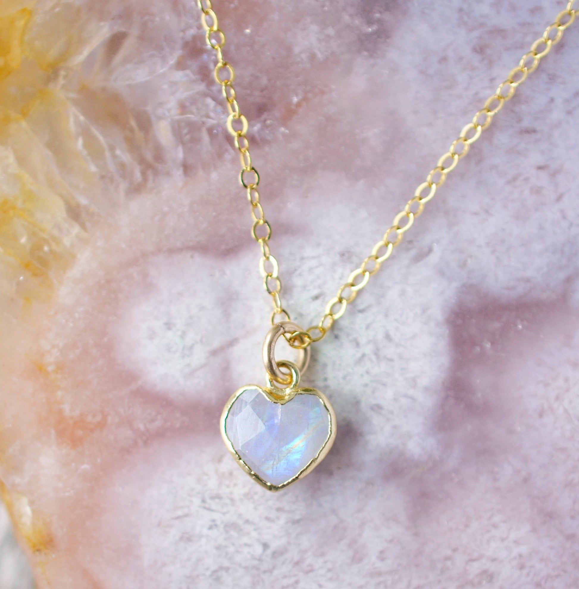 Natural rainbow moonstone heart pendant set onto a sterling silver or gold filled chain. Small stone heart pendant.