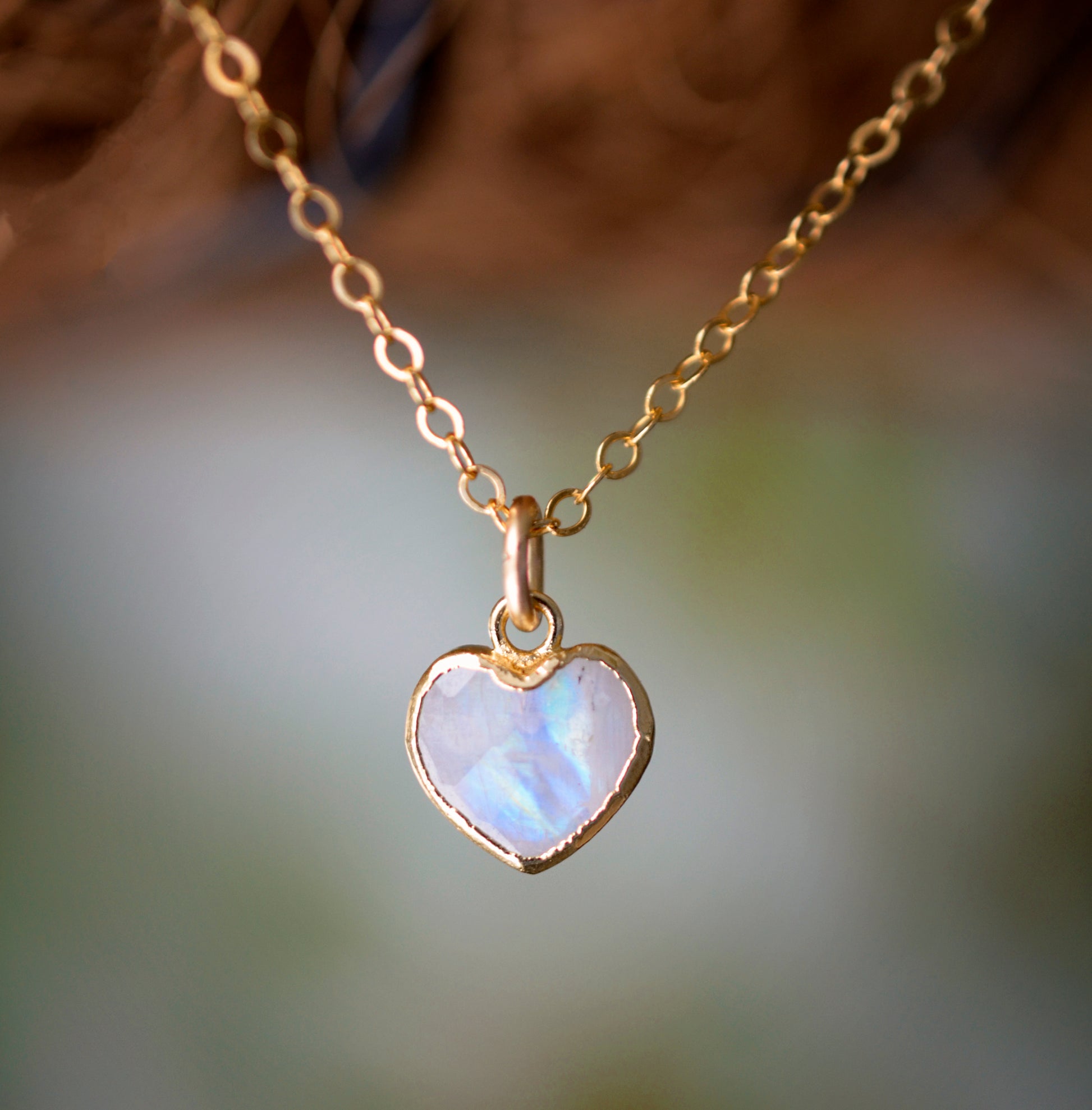 Natural rainbow moonstone heart pendant set onto a sterling silver or gold filled chain. Small stone heart pendant.
