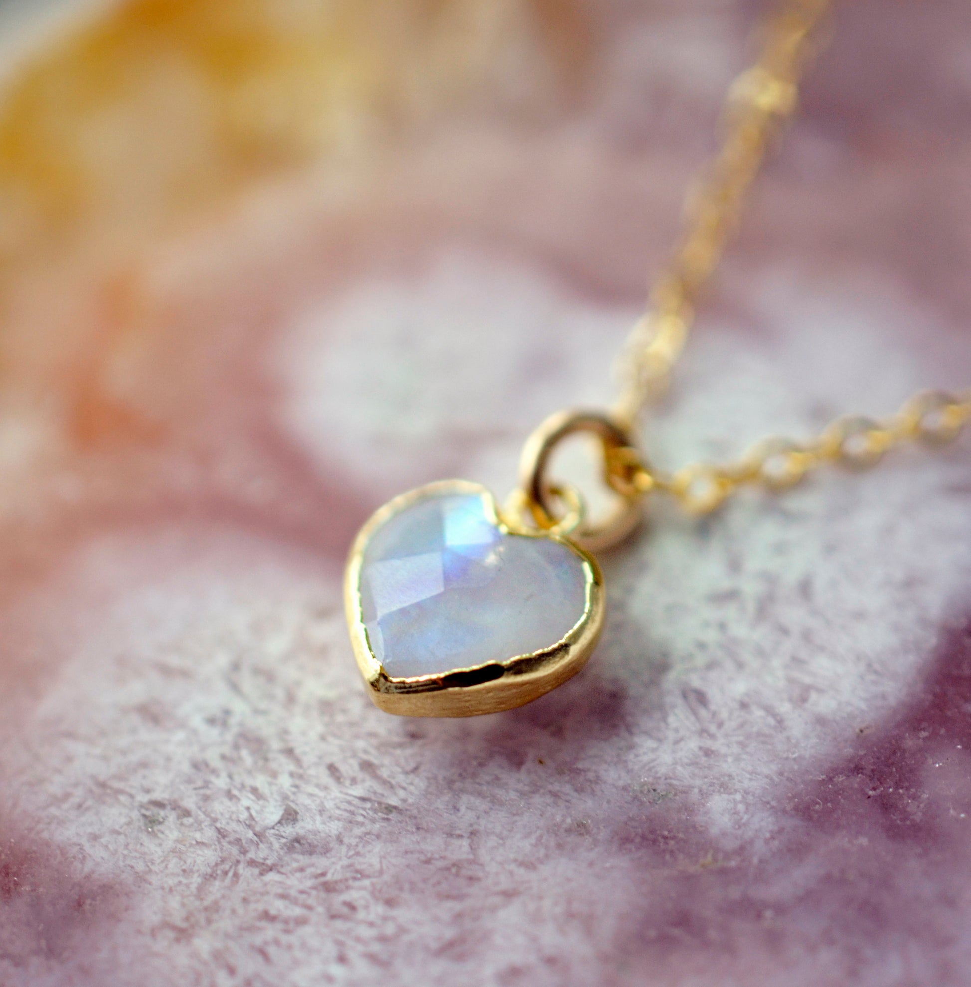 Natural rainbow moonstone heart pendant set onto a sterling silver or gold filled chain. Small stone heart pendant.