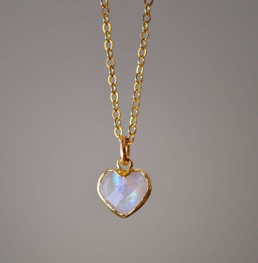 Natural rainbow moonstone heart pendant set onto a sterling silver or gold filled chain. Small stone heart pendant.