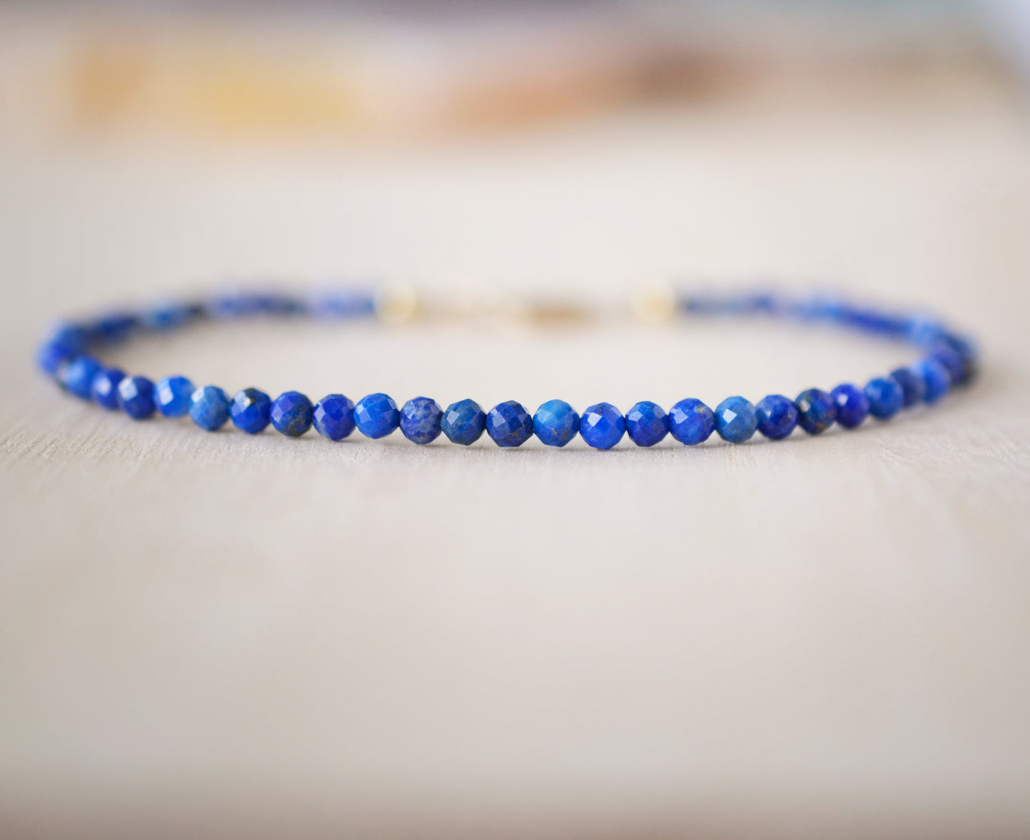 Minimalist Lapis Lazuli bracelet. Handmade with small 3mm natural lapis beads and set onto a sterling silver or 14k gold filled clasp.