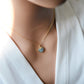 Pale blue natural aquamarine gemstone heart pendant set on a 14k gold filled chain. The stone is genuine and faceted with a 22k gold electroplate bezel.