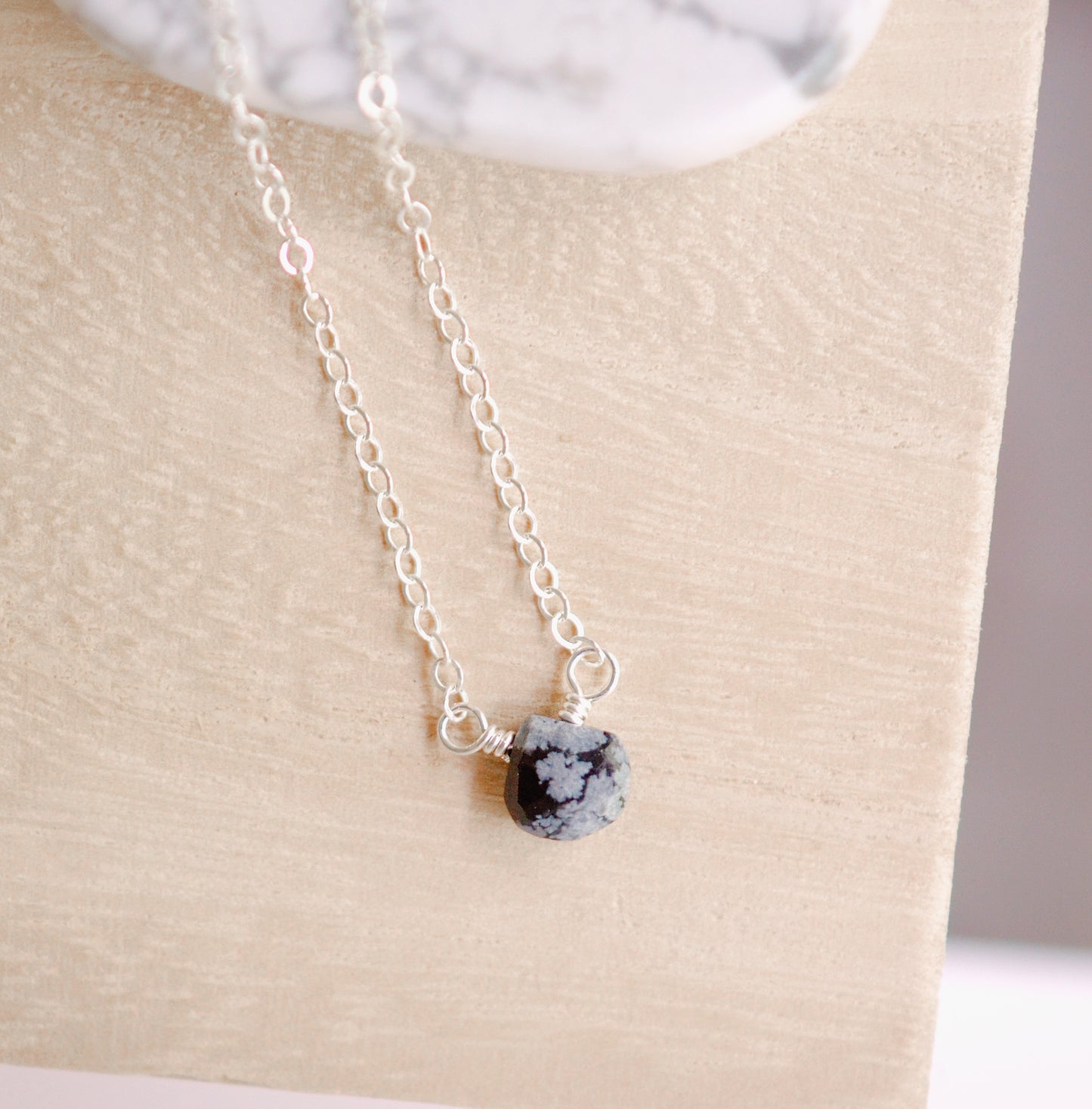 Genuine tiny snowflake obsidian crystal set on a sterling silver chain necklace.