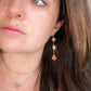 Rough clear quartz crystal and sunstone earrings modeled in gold.