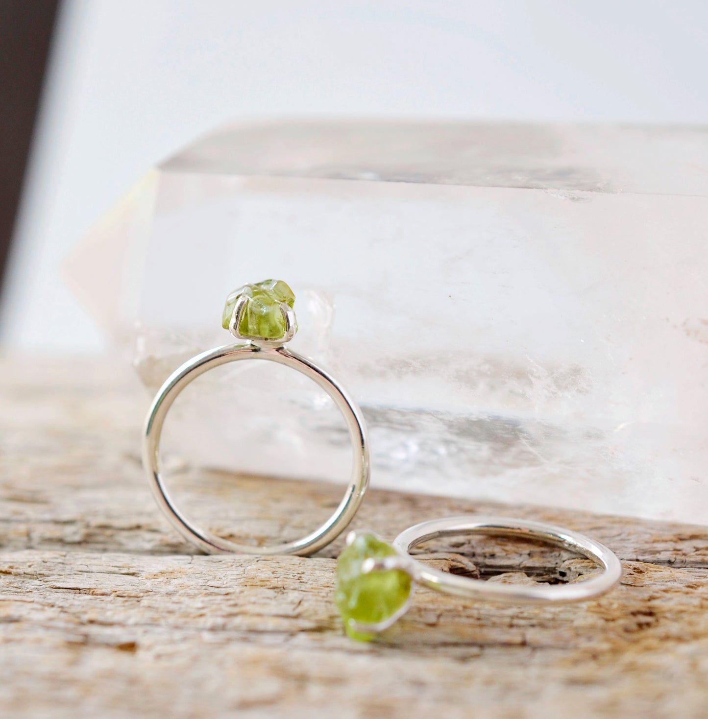 Raw green peridot ring on a sterling silver band. Close up image.