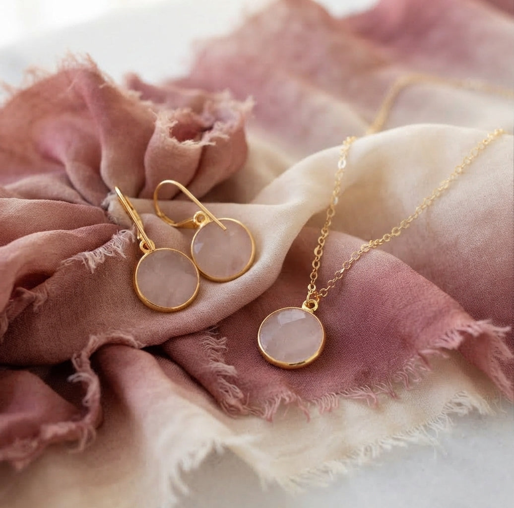 14k gold filled natural rose quartz jewelry set featuring a pendant necklace and matching drop earrings. The stones are a circle / coin shape and smooth polished. Also available in sterling silver. 