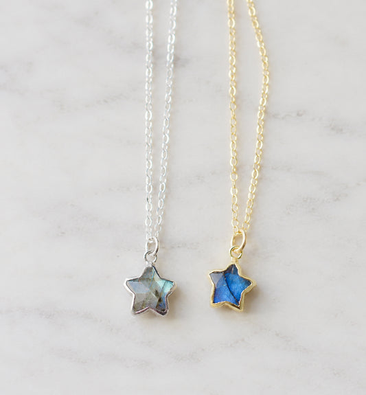 Two star-shaped natural labradorite celestial pendant necklaces on delicate chains, one in sterling silver silver and the other in 14k gold filled. Handmade jewelry in Connecticut by Gemnia.