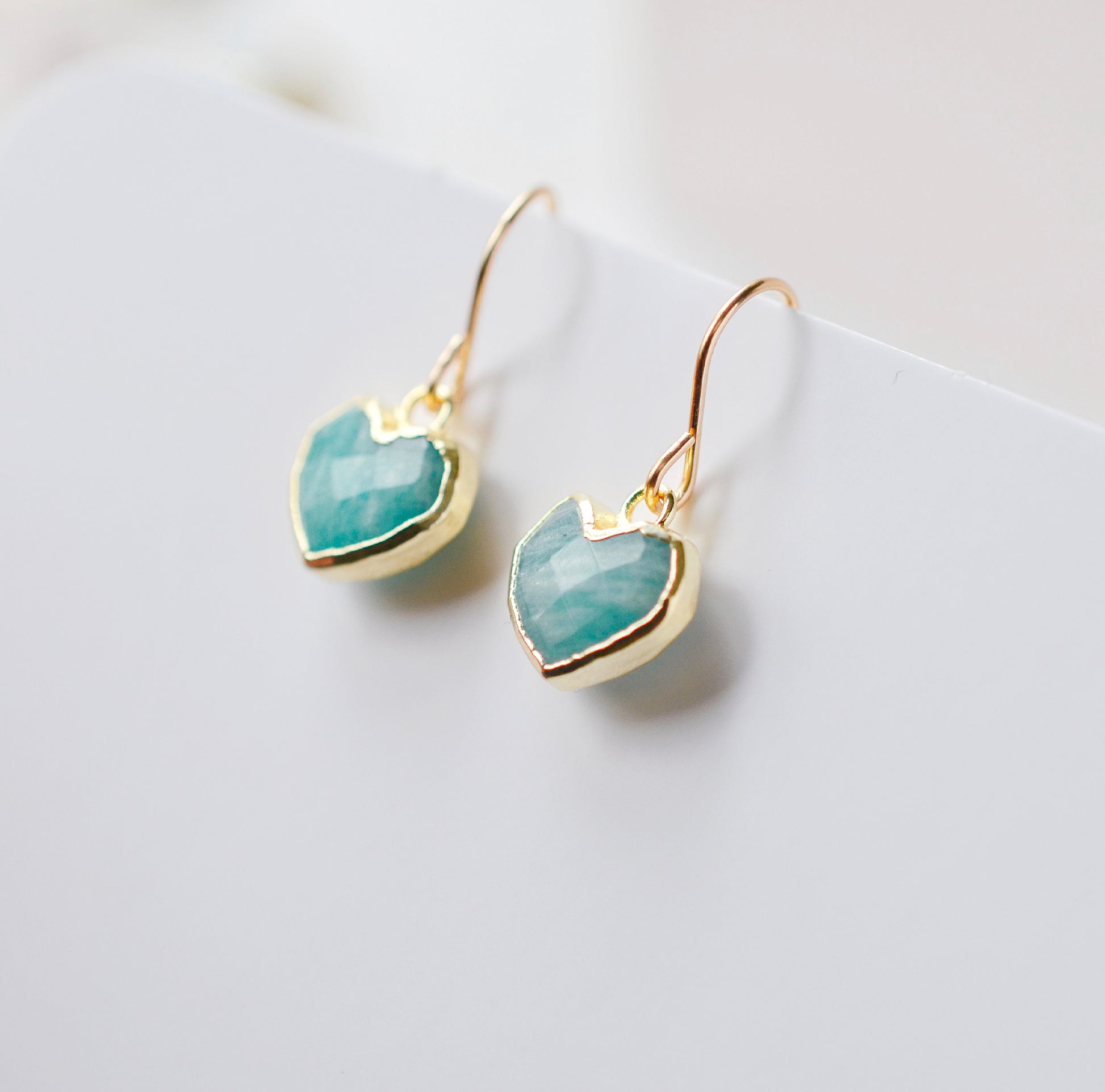 Aqua blue Amazonite gemstone heart earrings in gold. Modeled image. Natural Stones.