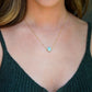 Genuine aqua blue Amazonite gemstone cut into a faceted cube and suspended on a gold filled cable chain. Modeled Image.