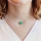 Aqua blue amazonite slice gemstone set onto a 14k gold filled chain. The stone is semi oval in shape, but irregular. It's smooth polished, but with raw edges. Modeled image.