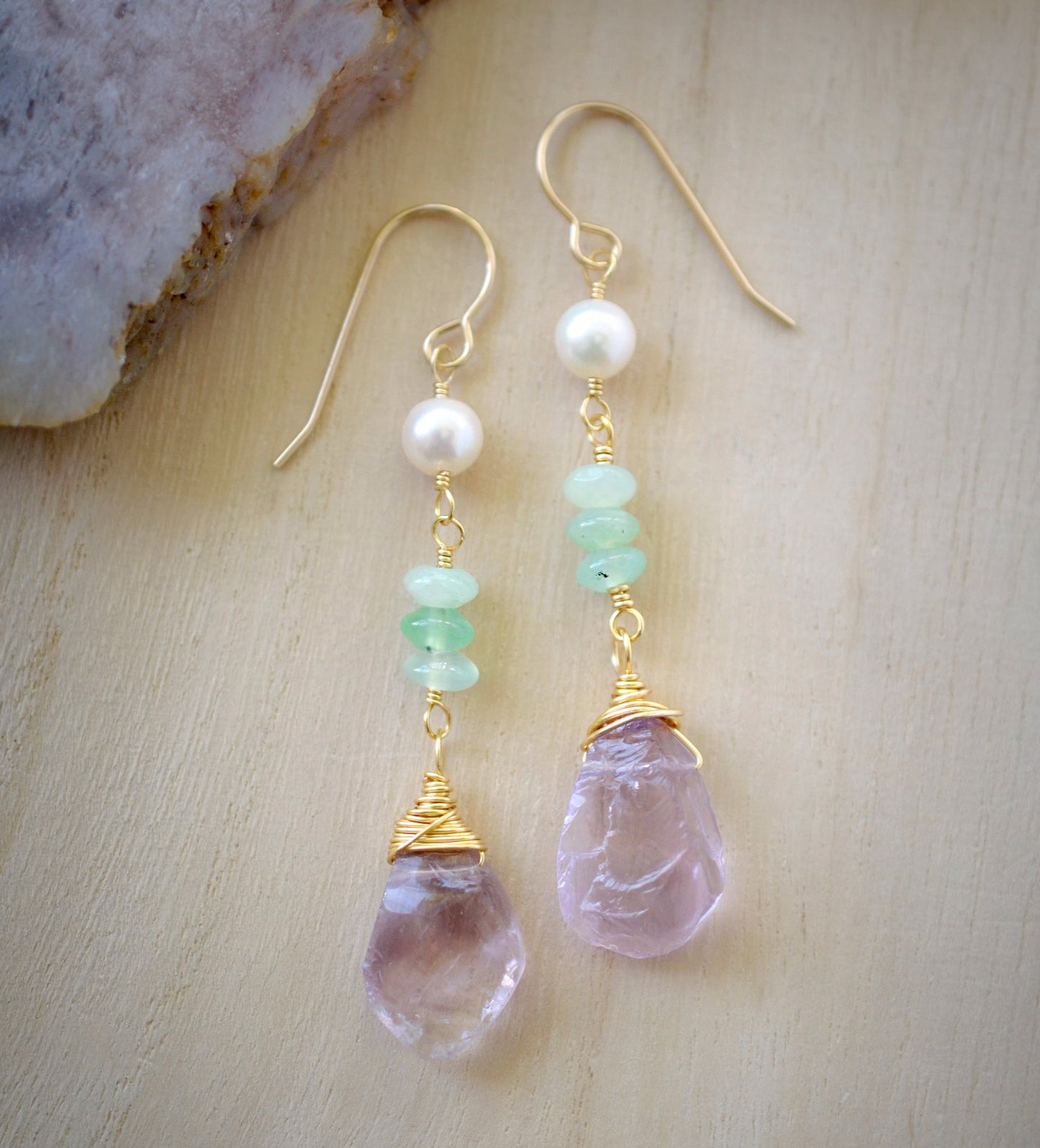 Detail image. Raw pale purple Amethyst gemstones dangle below three green chrysoprase stones and a single freshwater pearl. Shown in 14k gold filled. 