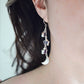 Three natural purple amethyst gemstone stars dangle atop rainbow moonstone crescent moons in these earrings. Shown in sterling silver. Modeled image.