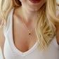 Natural purple amethyst heart stone pendant set onto a gold chain necklace. Modeled image.
