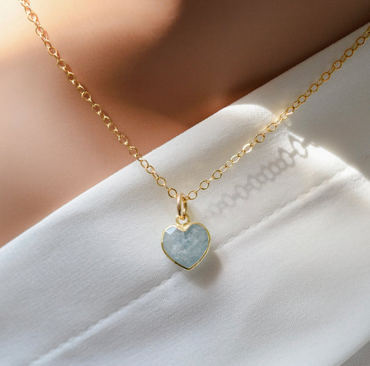 Pale blue natural aquamarine gemstone heart pendant set on a 14k gold filled chain. The stone is genuine and faceted with a 22k gold electroplate bezel.