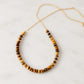 A beaded natural brown tigereye necklace set on a 14k gold filled chain with tiny gold glass beads in between. This handmade necklace is also available in sterling silver. 