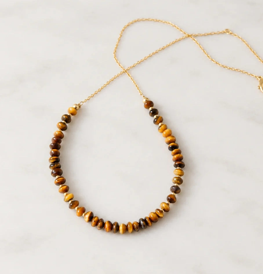A beaded natural brown tigereye necklace set on a 14k gold filled chain with tiny gold glass beads in between. This handmade necklace is also available in sterling silver. 