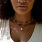 Handmade Cowrie shell necklace modeled with beaded gemstone necklaces.