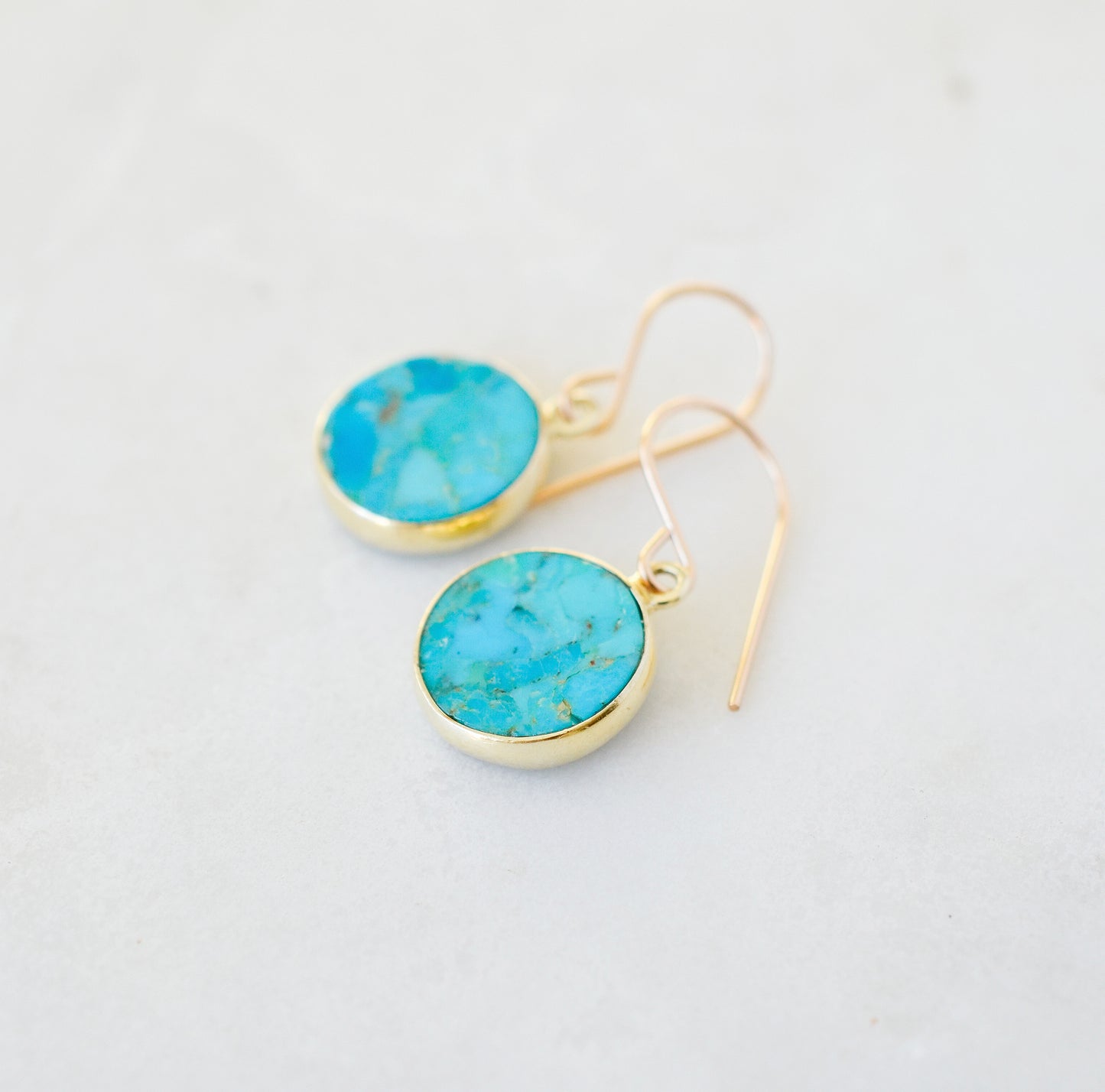 Natural round coin shaped blue turquoise earring dangles in 14k gold filled. Dainty handmade gemstone jewelry.