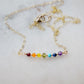 Gemstone bar necklace shown in 14k gold filled. The stones are arranged in the colors or the rainbow or chakras.
