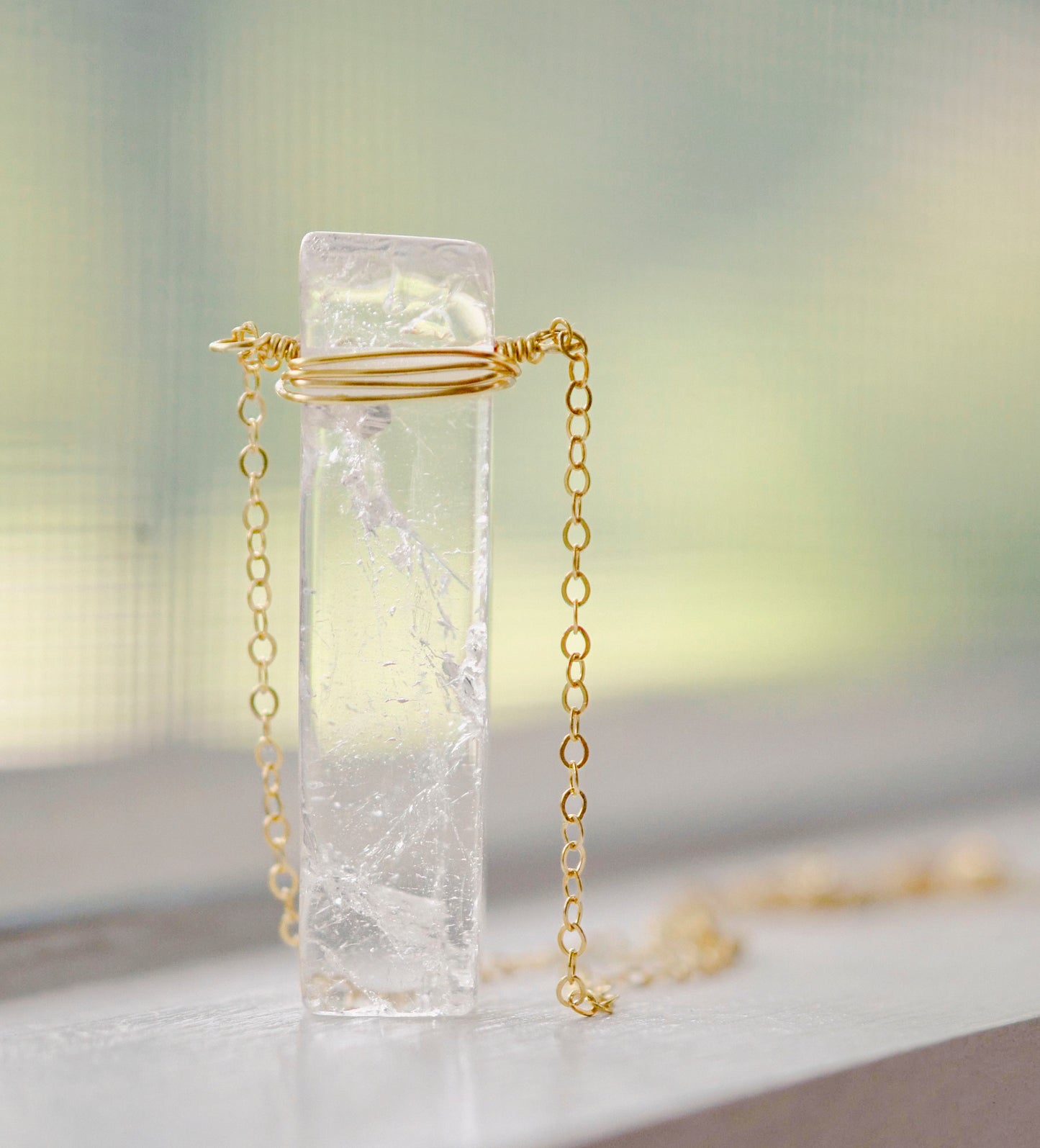 Rectangular shaped natural clear crystal Quartz gemstone set into a 14k gold filled chain. 