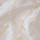 Genuine white freshwater pearls of varying sizes alter on this chain necklace. The gold style is shown.
