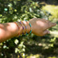 Handmade beaded gemstone crystal bracelet in gold filled or sterling silver. These bracelets feature a gemstone of your choice on a bracelet that can be stacked with others or worn alone. Modeled image showing: turquoise, tanzanite, amethyst, and sunstone.