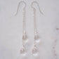 Long clear crystal quartz earrings with two teardrop dangles hanging from a dainty sterling silver chain.