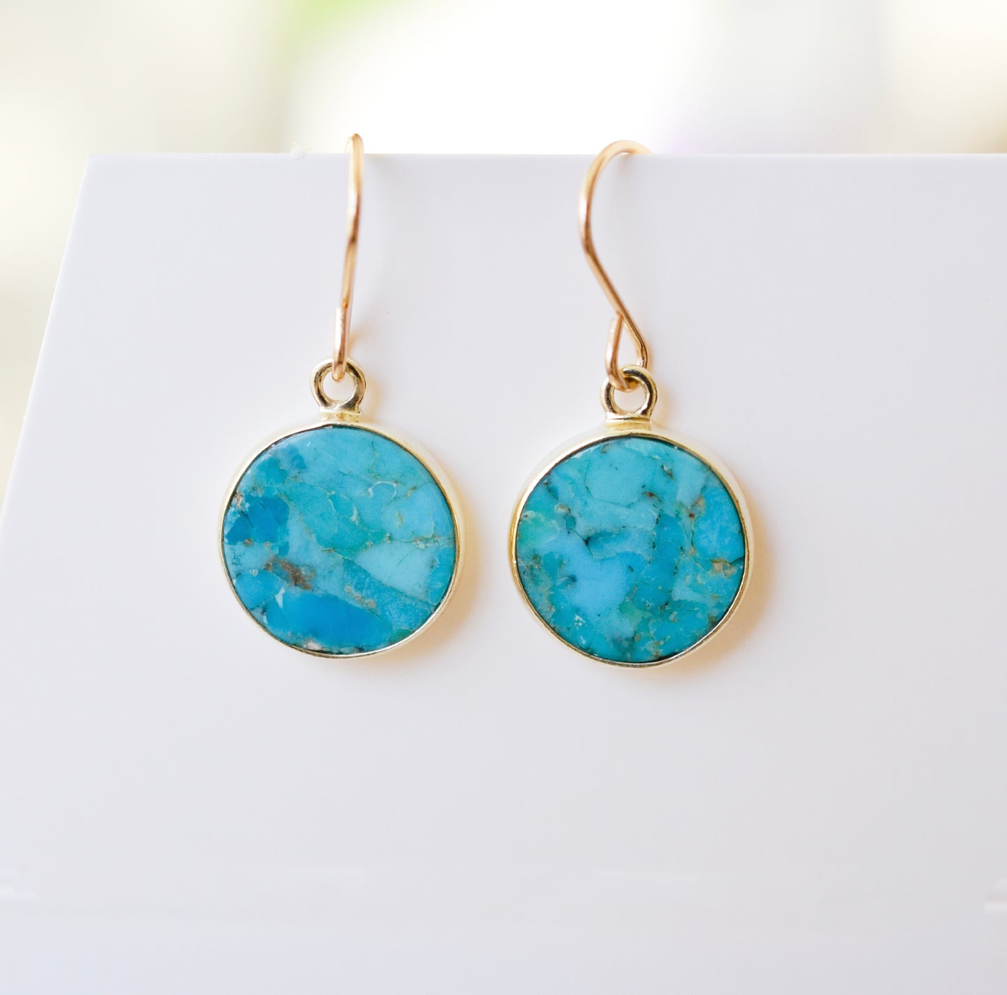 Turquoise earring dangles handmade with 14k gold filled or sterling silver metal. These drops are a minimalist geometric style with flat round gemstones.