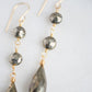 Close up of faceted pyrite crystals in the long dangle earrings.