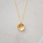 Om symbol stamped into a circle disc and put on a gold filled chain.