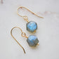 Blue flashing Labradorite gemstones in a faceted hexagonal shape dangle from 14k gold filled earring hooks. Small gold beads accent below the stone. Also available in sterling silver.