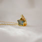 A close up image of a dainty handmade labradorite gemstone star pendant set on a 14k gold filled chain.
