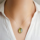 Labradorite oval pendant with yellow-green flash. The chain in 14k gold filled. Modeled image.