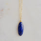 A handmade natural genuine blue lapis lazuli gemstone pendant on a dainty 14k gold filled chain. This necklace is made in Connecticut by Gemnia Jewelry.