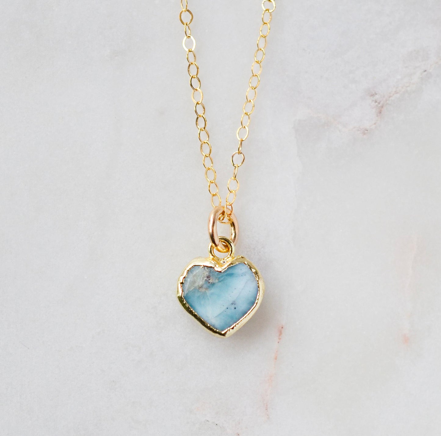 Genuine, real, blue Larimar stone heart necklace. The stone is bezeled in gold and set on a 14k gold filled cable chain. This pendant is a great romantic gift for wife, girlfriend, or valentine's day.