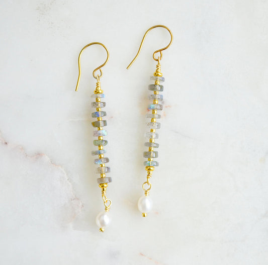 Handmade beaded dangle earrings with labradorite and white freshwater pearls. These artisan earrings are a long bar style with dainty pearls on the bottom. The gemstones flash blue and green.