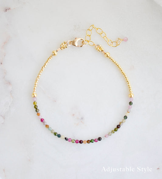 Tiny mulit-color Tourmaline faceted round crystals on a gold beaded bracelet. The adjustable style is shown.